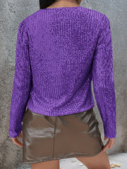 Purple sequin bolero jacket with long sleeves and puffed shoulders.