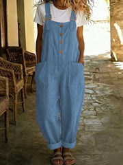 Blue wide leg romper with buttons and pockets, worn with a white tee.