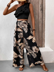 Black asymmetrical ruffle crop top with wide-leg palm print pants.