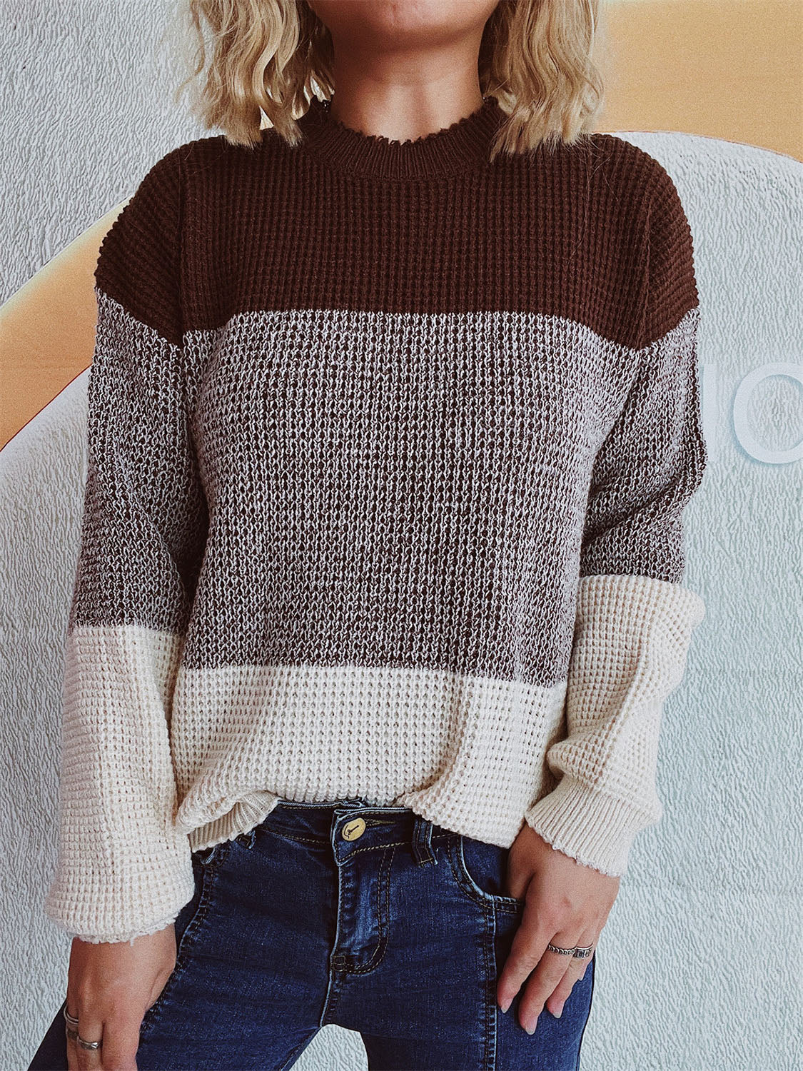 Colorblock textured knit pullover sweater with mock neck and long sleeves in brown, grey, and cream.