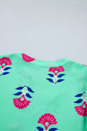 Mint green blouse with embroidered floral print, V-neck, and flutter sleeves.