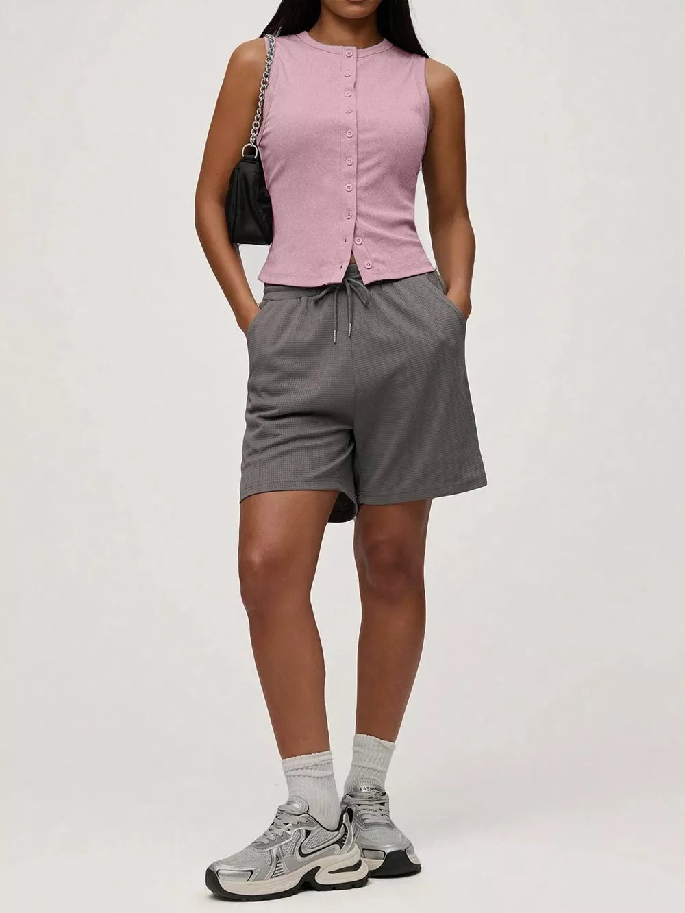Pink ribbed button-front fitted tank top with a crew neck and sleeveless design.