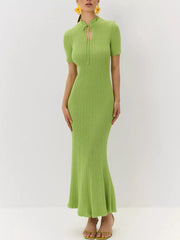Lime green knitted mermaid dress with short sleeves and a tied neckline.