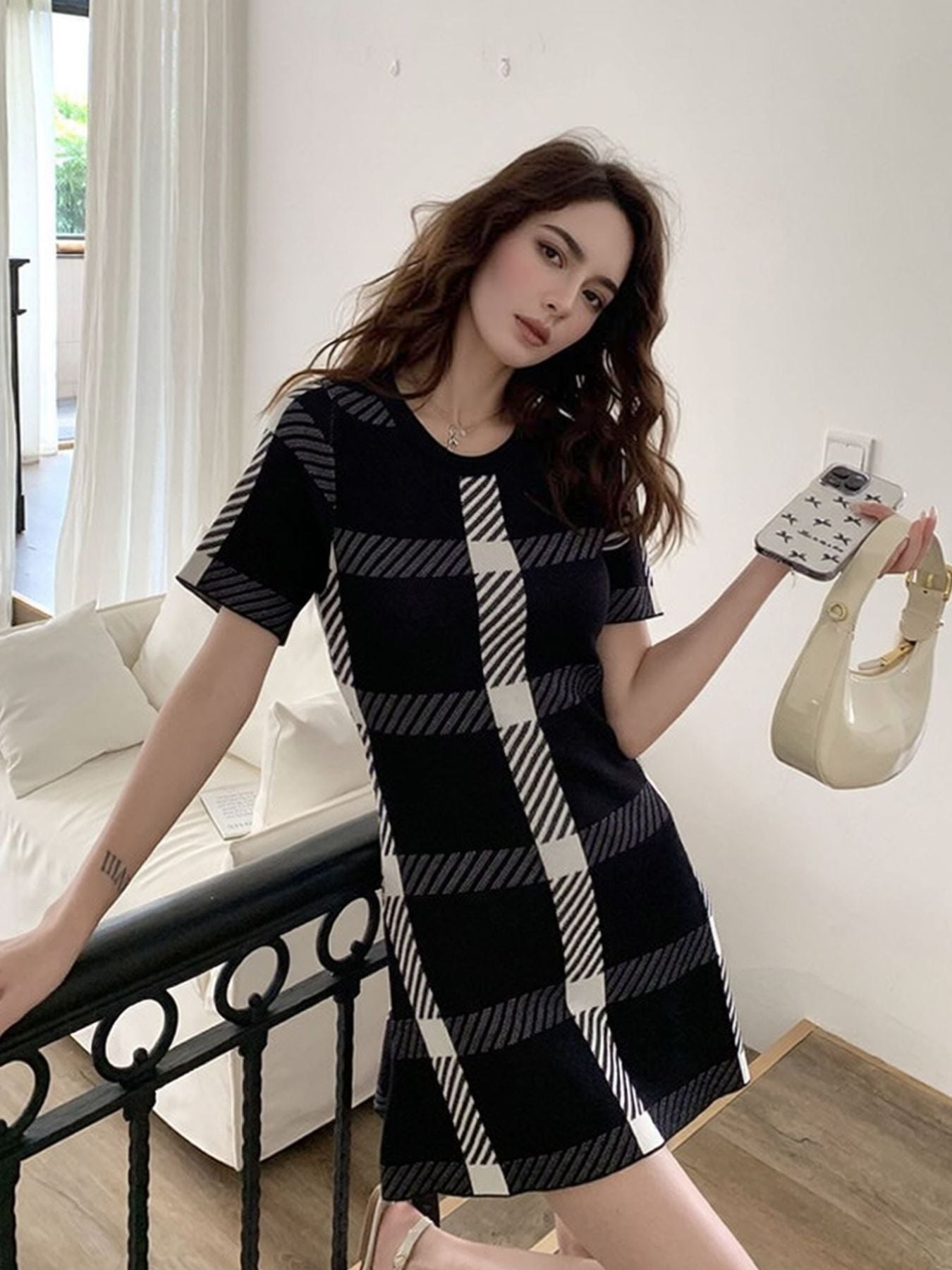 Black and white plaid mini dress with short sleeves and a round neckline.