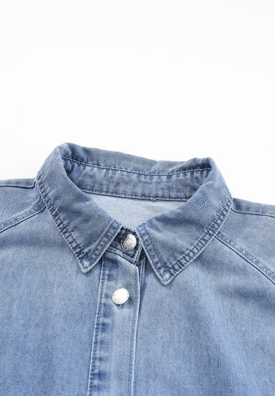Light blue denim shirtdress with button front and collared neckline.