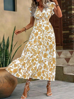 Botanical ruffle sleeve midi dress in white with yellow print, V-neck, cinched waist, tiered skirt.
