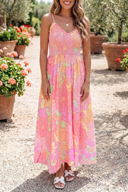 Floral smocked high waist maxi dress in pink with a vibrant floral print and V-neck.