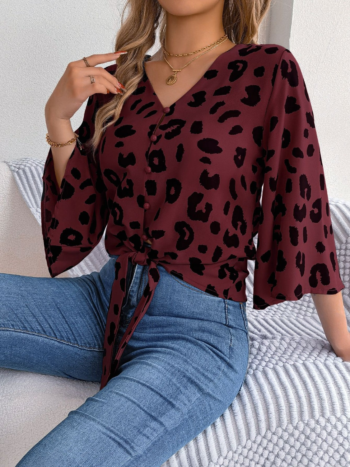 Burgundy leopard print tie-front blouse with V-neck and button detail
