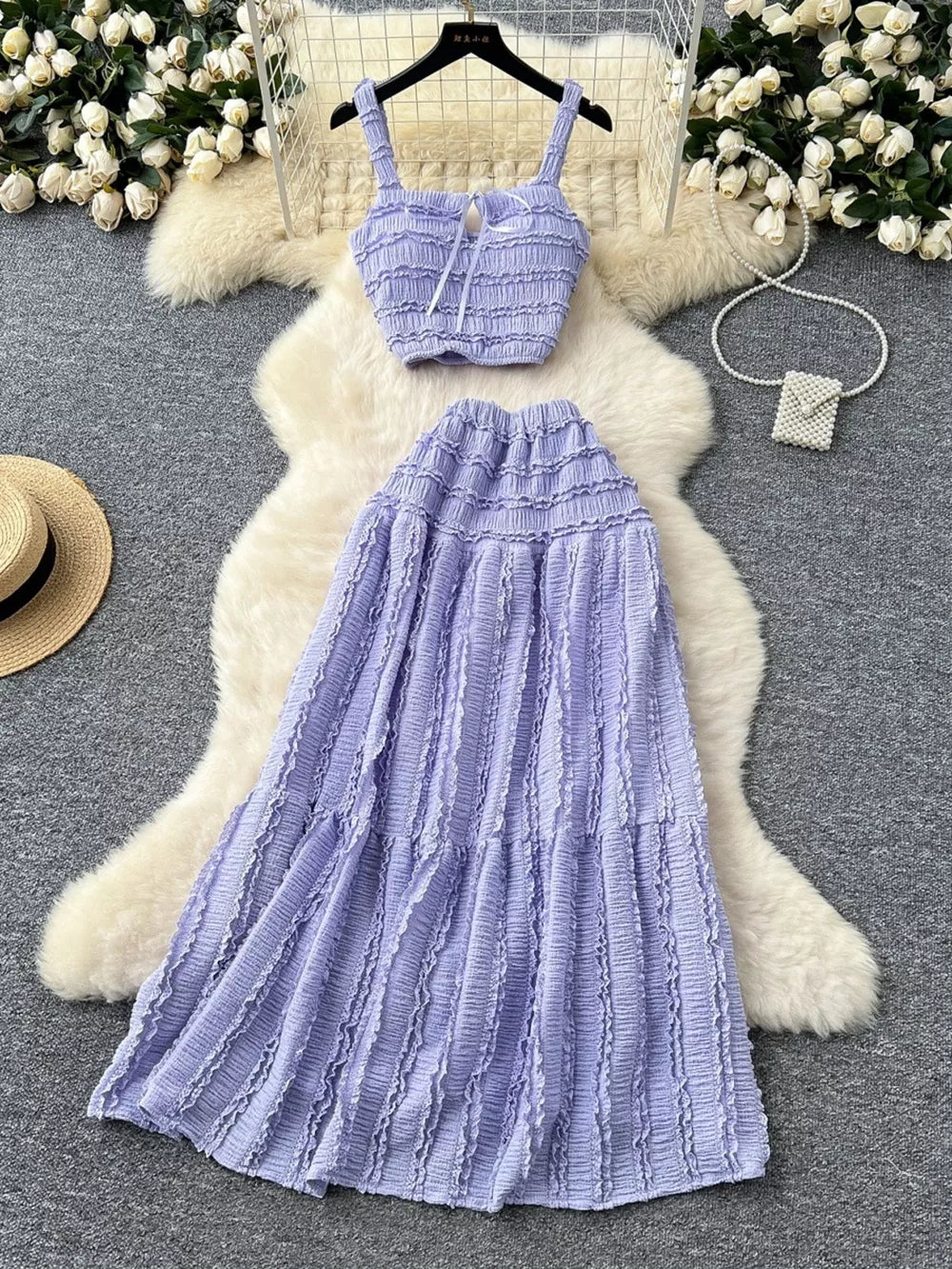 Purple ruched crop top and maxi skirt set with tie detail.