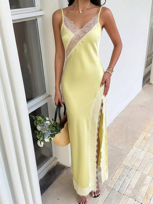 Yellow lace-trimmed midi slip dress with side slit and V-neck.