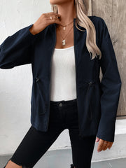 Navy cinched waist utility jacket with drawstring detail, zip front, and long sleeves.