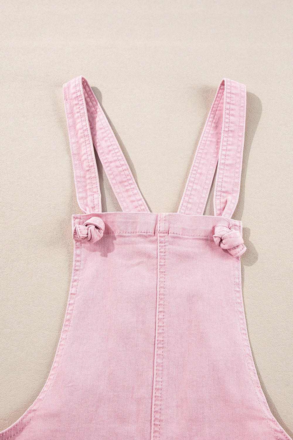 Blush pink denim short overalls with knotted strap details