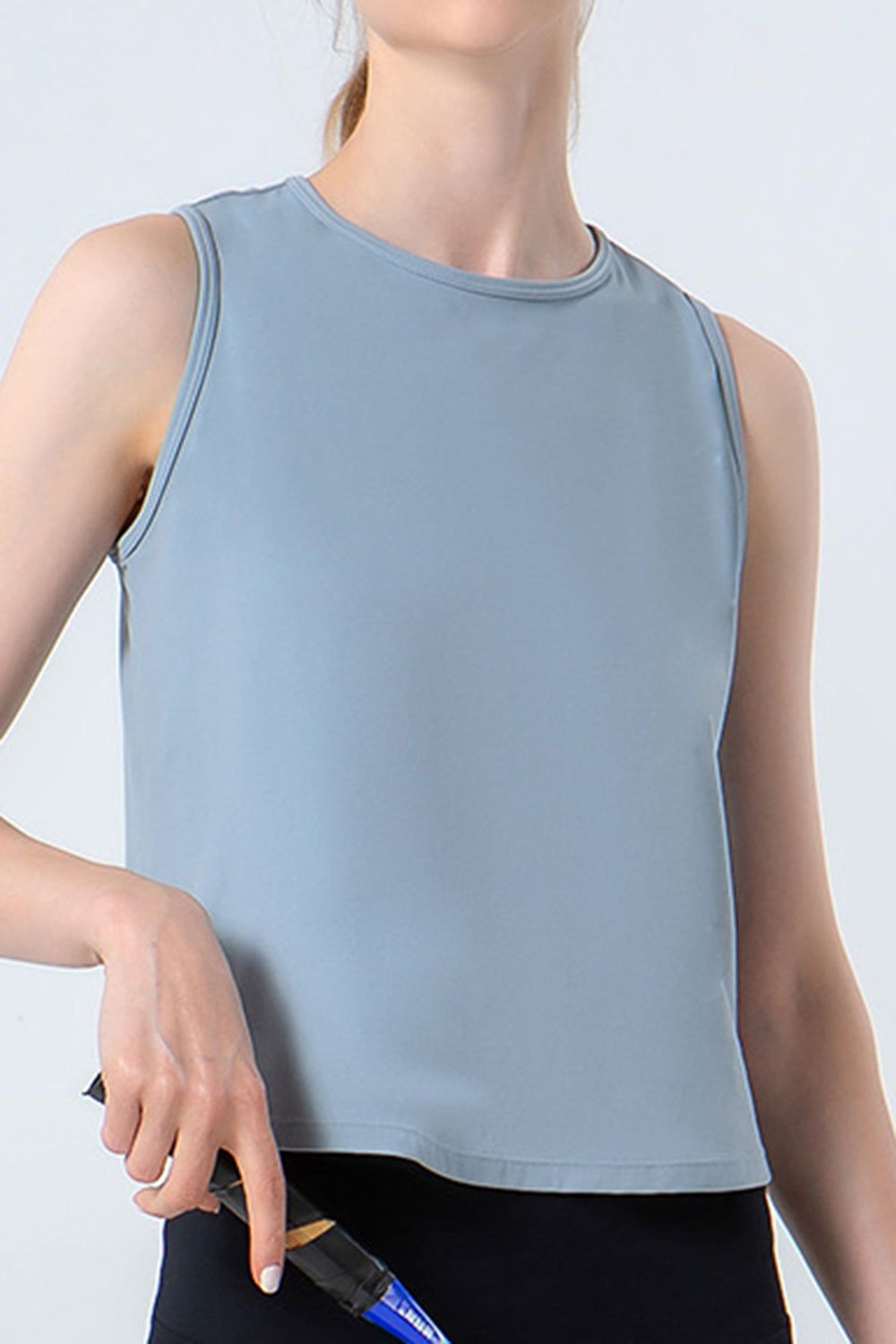 Dusty blue performance tank top with a round neckline and sleeveless cut.