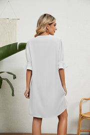 White V-neck shift dress with flutter sleeves and a relaxed fit.