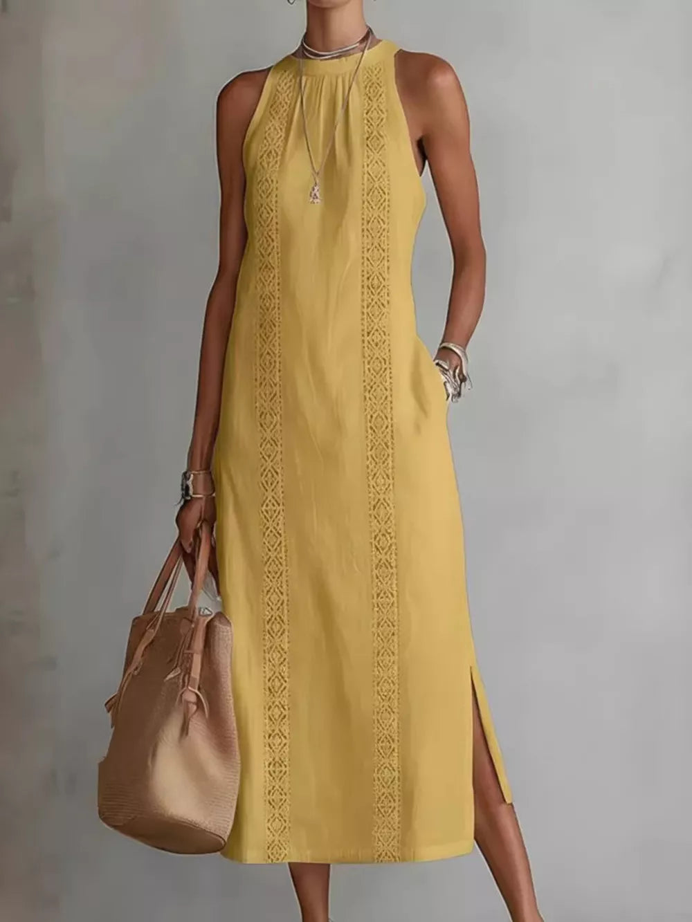 Yellow sleeveless midi dress with geometric trim and pockets, side slits.