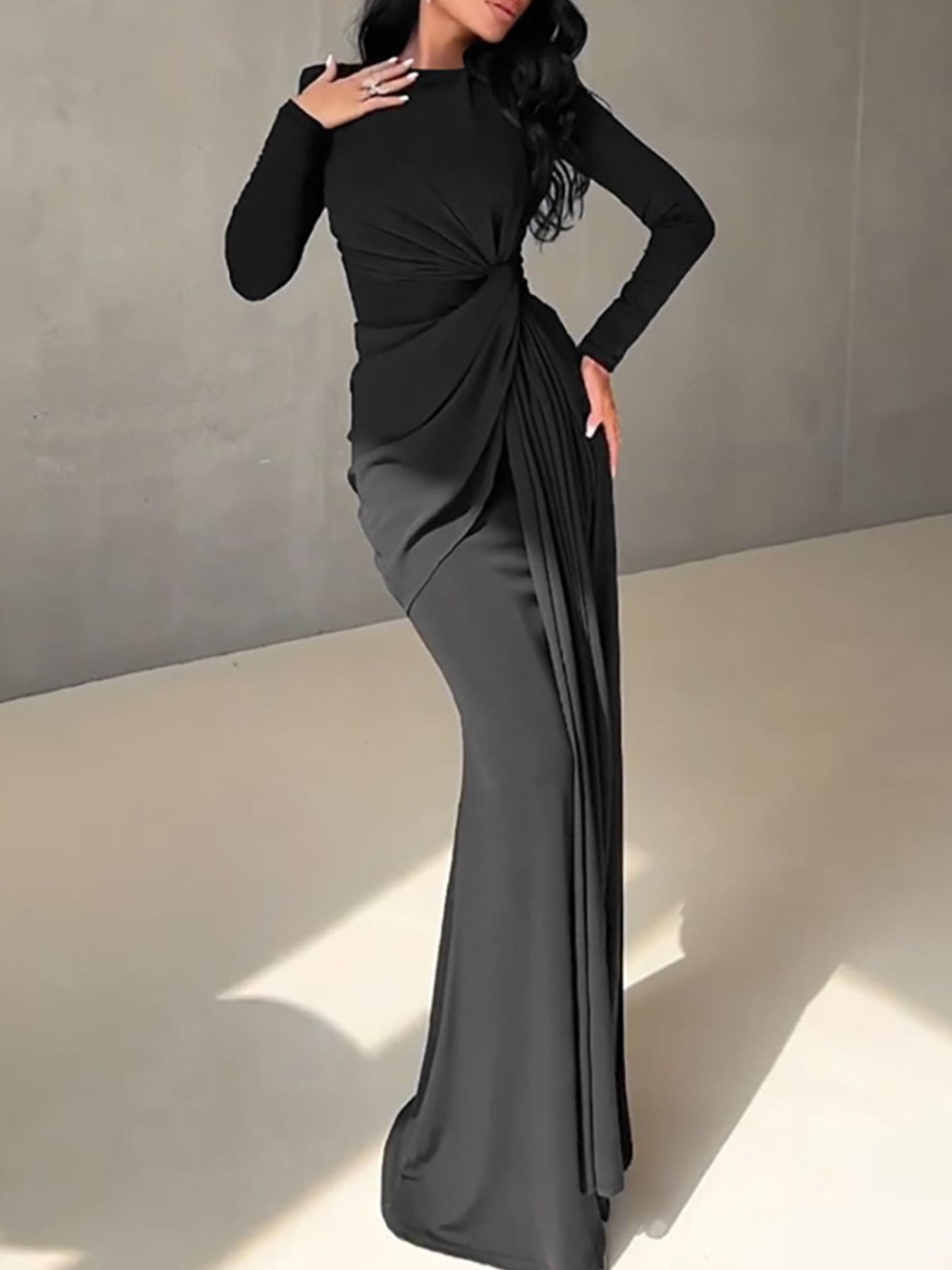 Black long sleeve ruched knot front maxi dress with draped skirt detail.