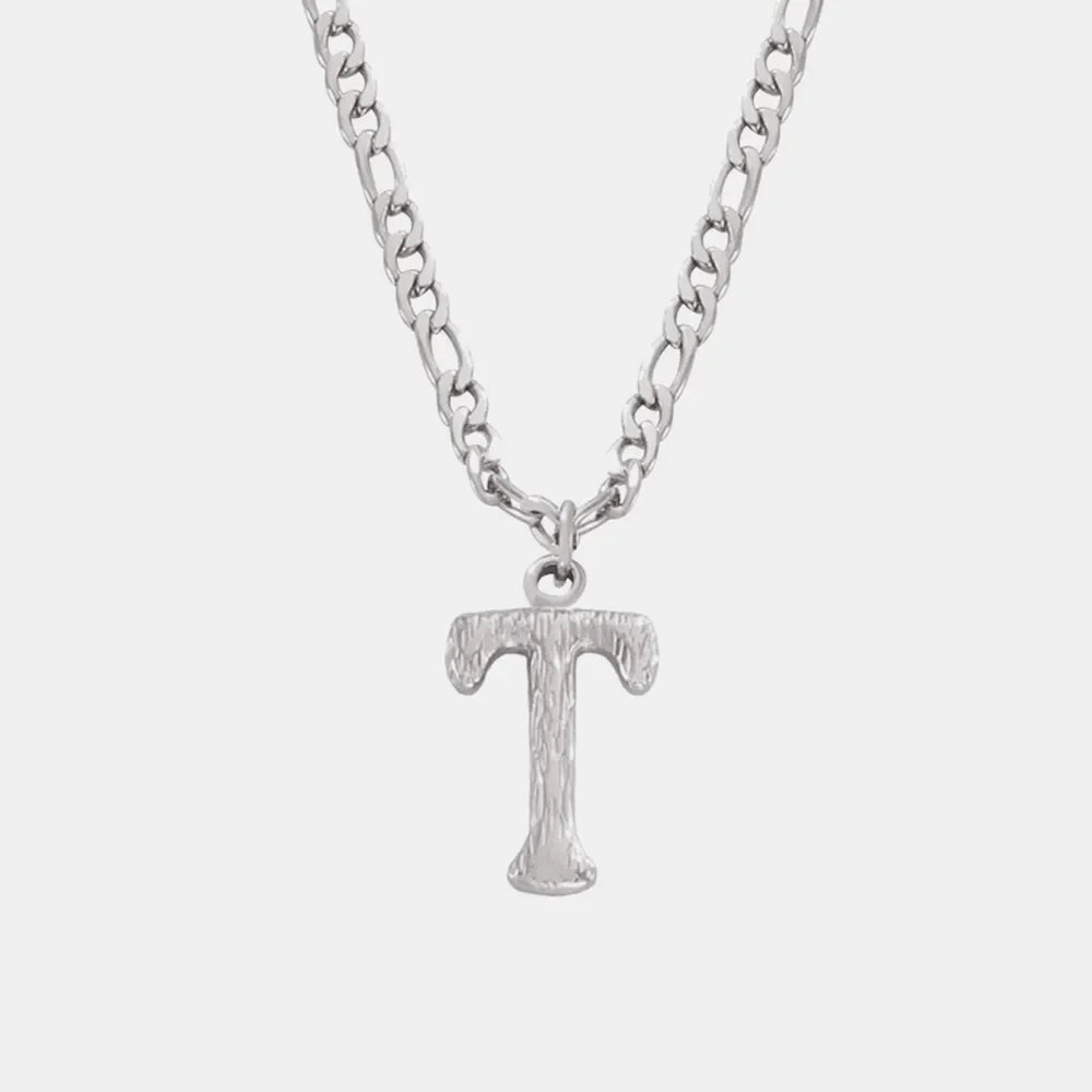 Silver textured initial pendant necklace with a figaro chain.