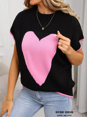 Black acrylic knit top with pink heart graphic and ribbed trim. Crew neck, short sleeves.
