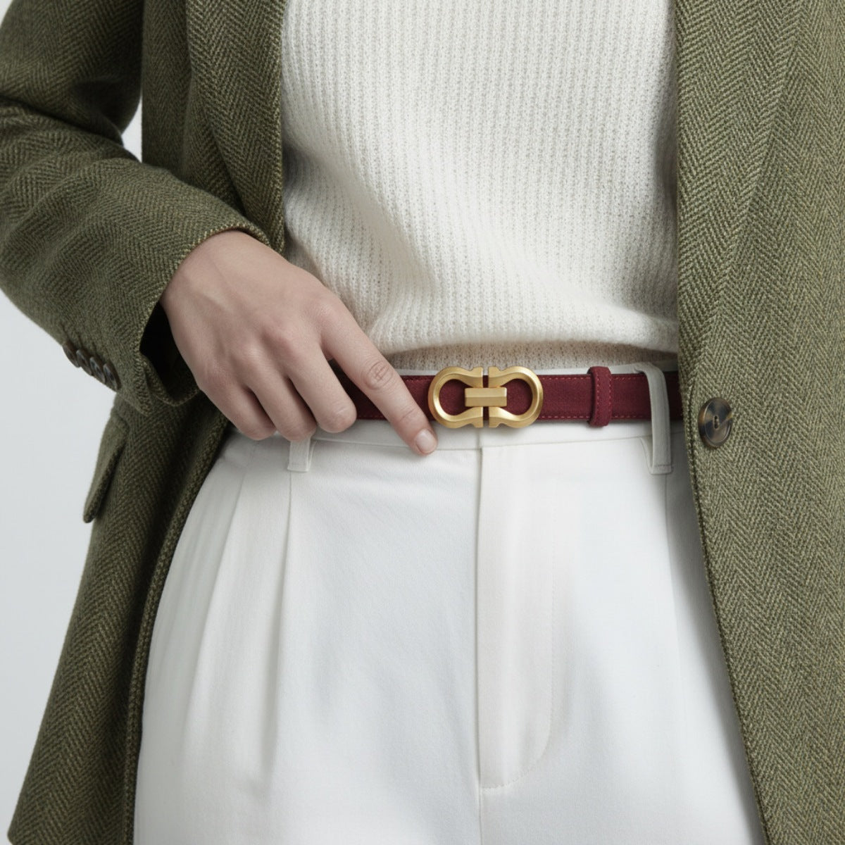 Red cowhide leather belt with gold double G buckle, styled with white pants and a green blazer.