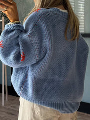 Light blue acrylic knit jumper with red western boot intarsia detail and subtle red stitching.