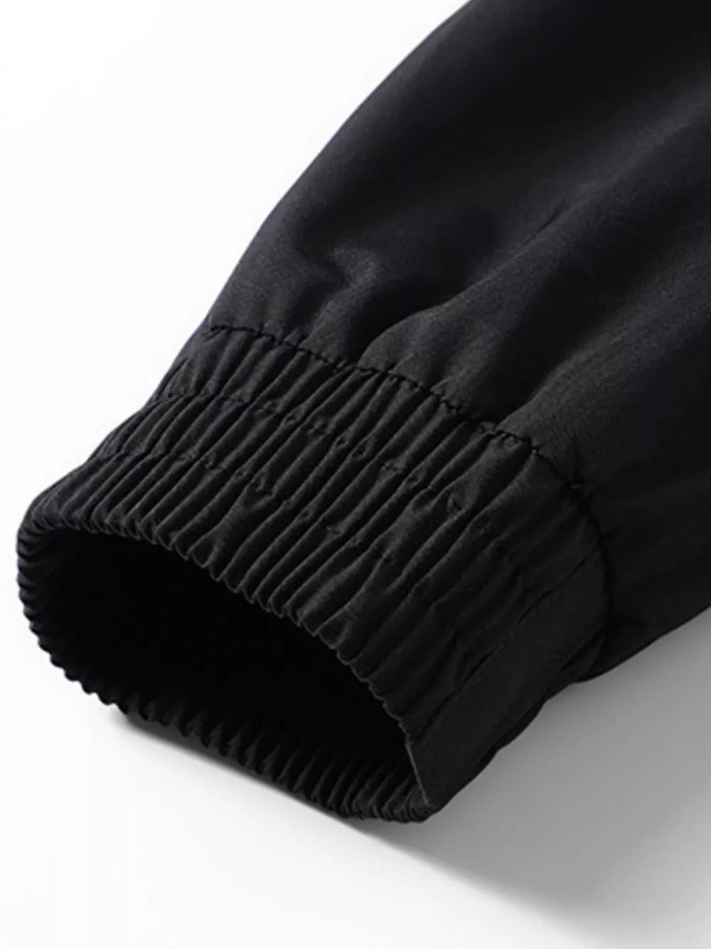 Black bomber jacket sleeve detail with ribbed elastic cuff