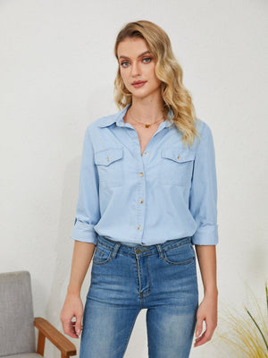 Light wash denim utility shirt with button-up front and two chest pockets.