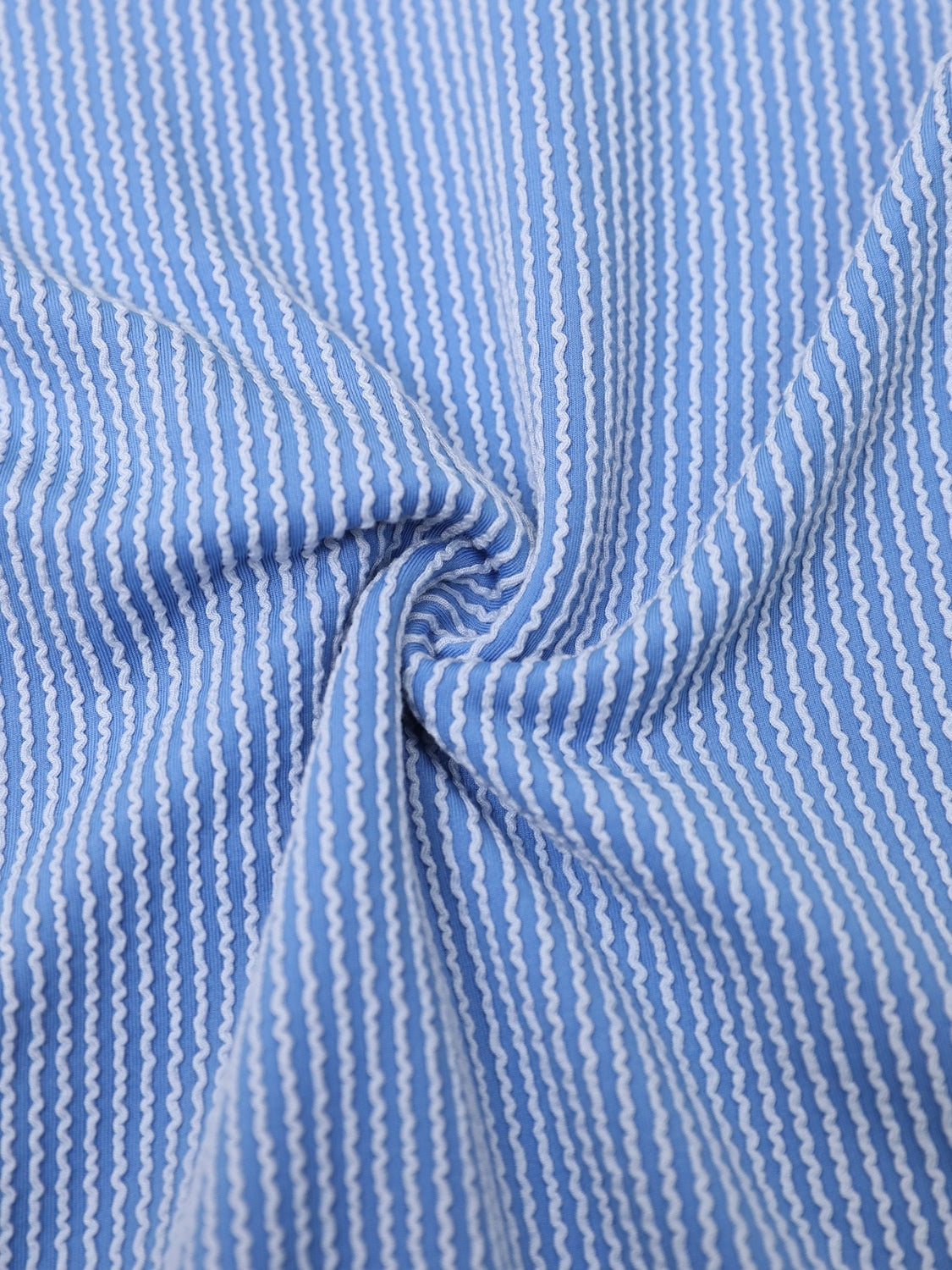 Sky blue ribbed knit romper with white vertical wavy stripes.
