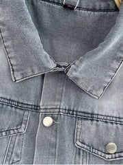 Light wash denim romper with button front and chest pockets.