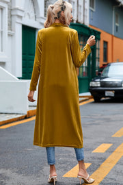 Mustard velvet duster coat with long sleeves, open front, and a relaxed fit.