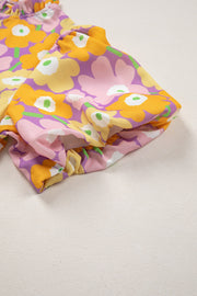 Puff sleeve blouse with ruffle trim in a colorful floral print.