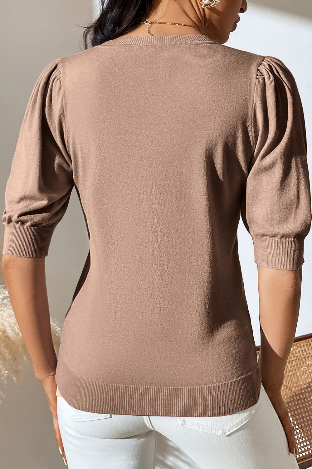 Camel knit sweater with puff sleeves and ribbed cuffs and hem.
