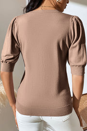 Camel knit sweater with puff sleeves and ribbed cuffs and hem.
