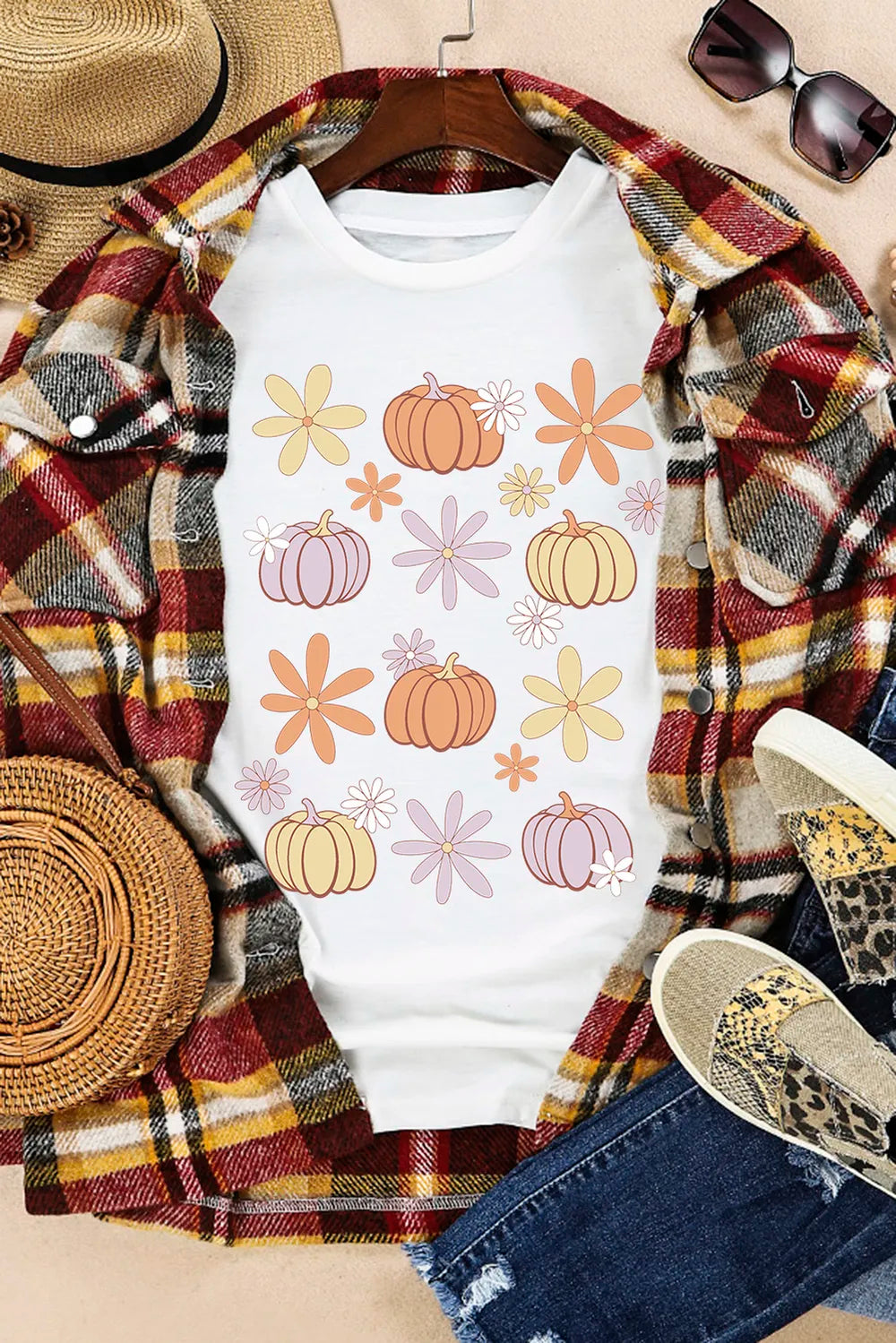 White t-shirt with a groovy pumpkin and flower graphic print, casual autumn style