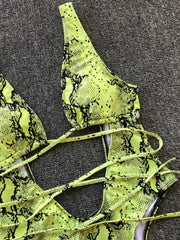 Yellow-green snakeskin plunge swimsuit with crisscross straps and cutout detail.