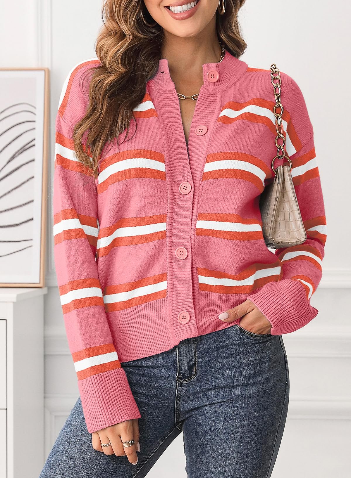 Pink striped knit cardigan with button front and mock neck.