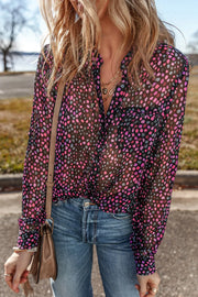 Sheer dotted blouse in black with knot detail and button front, styled with jeans.