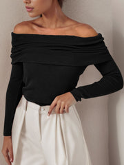 Black off the shoulder knit sweater with draped neckline and long sleeves.
