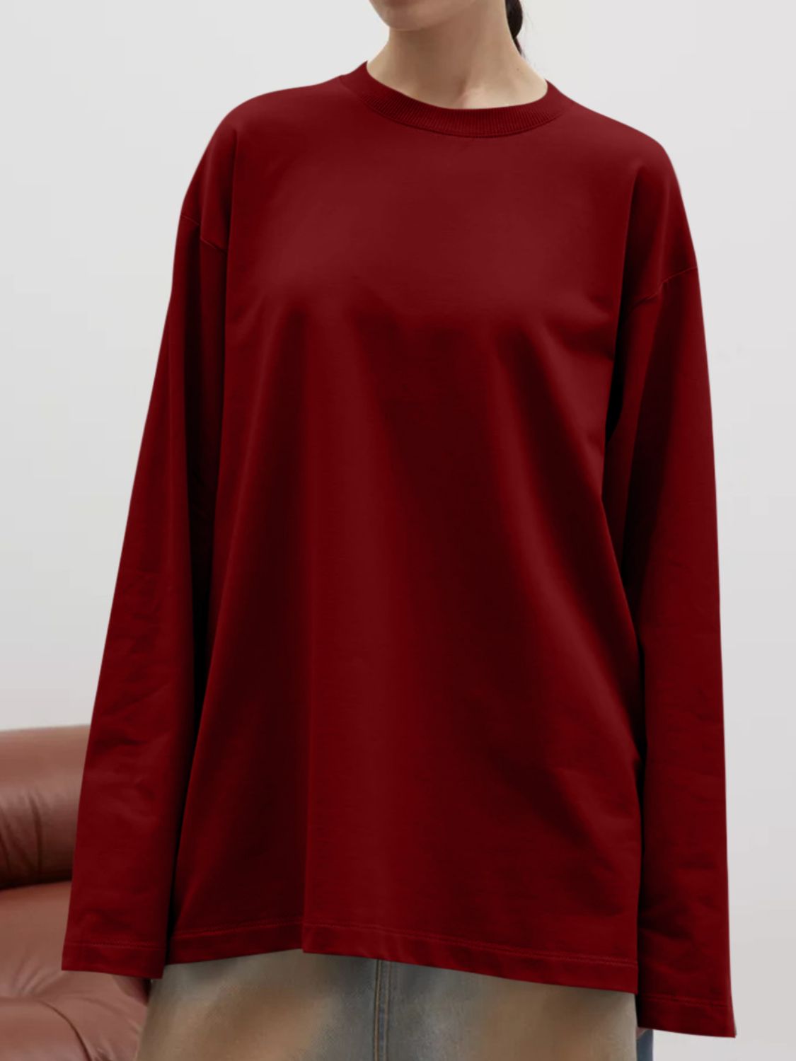 Burgundy oversized crewneck sweatshirt with voluminous sleeves and a relaxed fit.