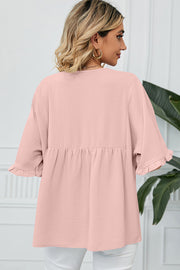 Gathered yoke flutter sleeve blouse in watermelon pink with ruffled cuffs and a babydoll hem.