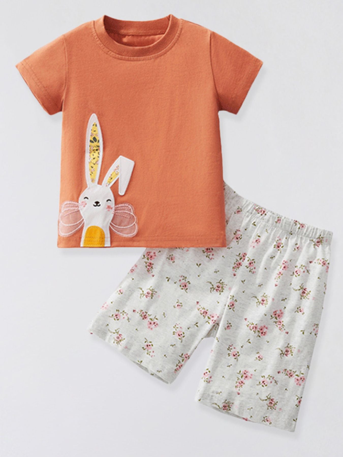 Orange cotton tee with bunny applique and floral print shorts for baby girls.