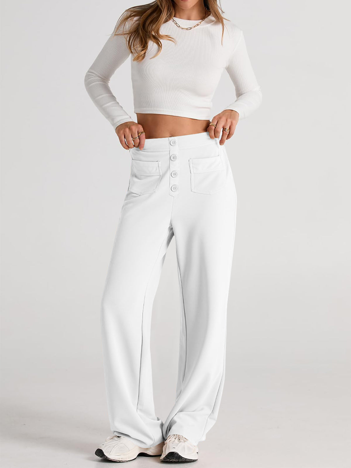 White button-front palazzo trousers with four decorative buttons and flap pockets.