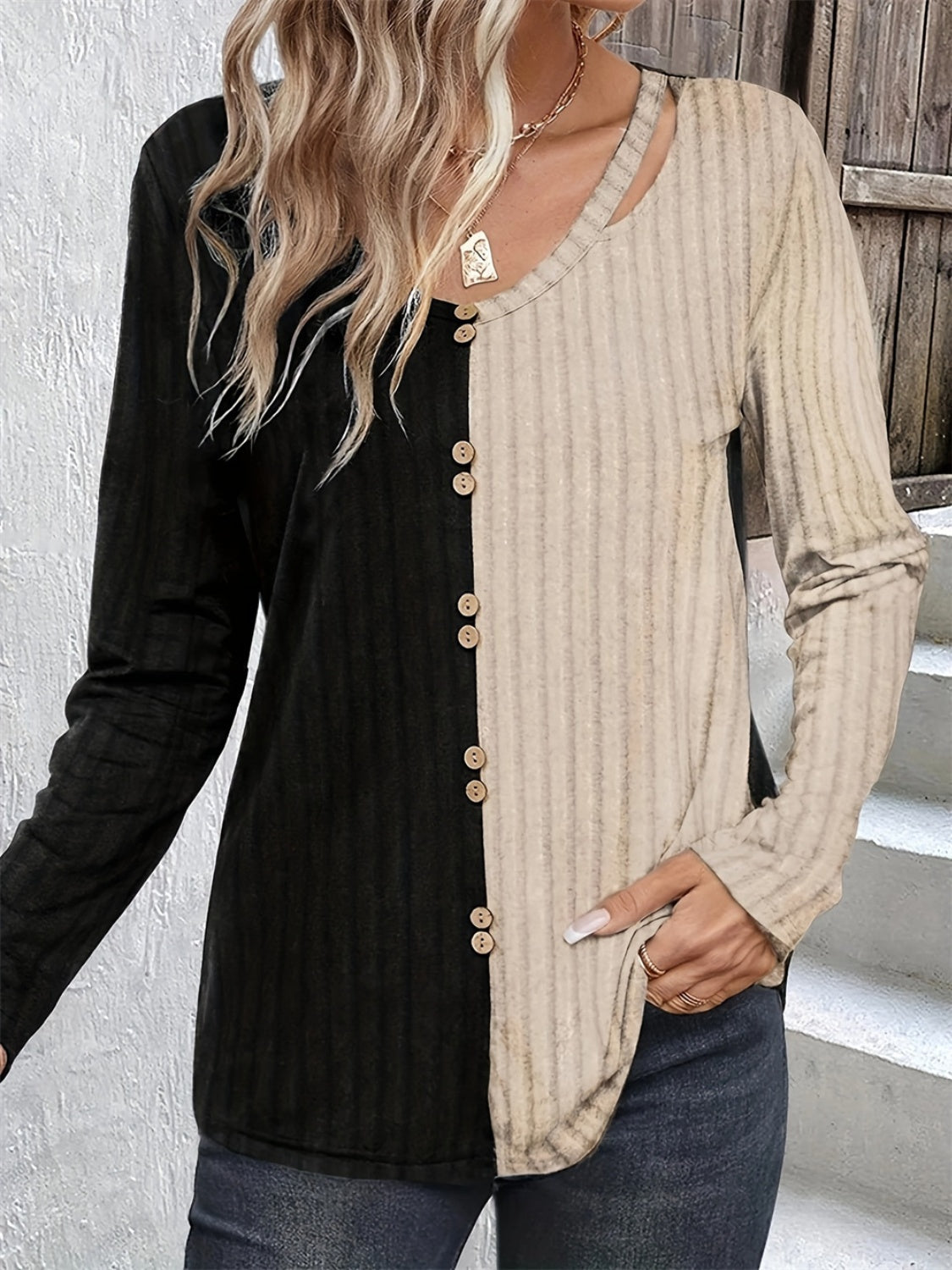 Split-panel ribbed henley top in black and beige with button front and cutout neckline.