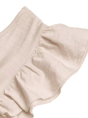 Beige ruffled V-neck wide-leg romper with textured fabric detail.