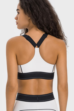 White performance sports bra with black crossback straps and band