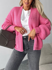Hot pink textured puff sleeve cardigan with pockets, open front, and ribbed knit detail.