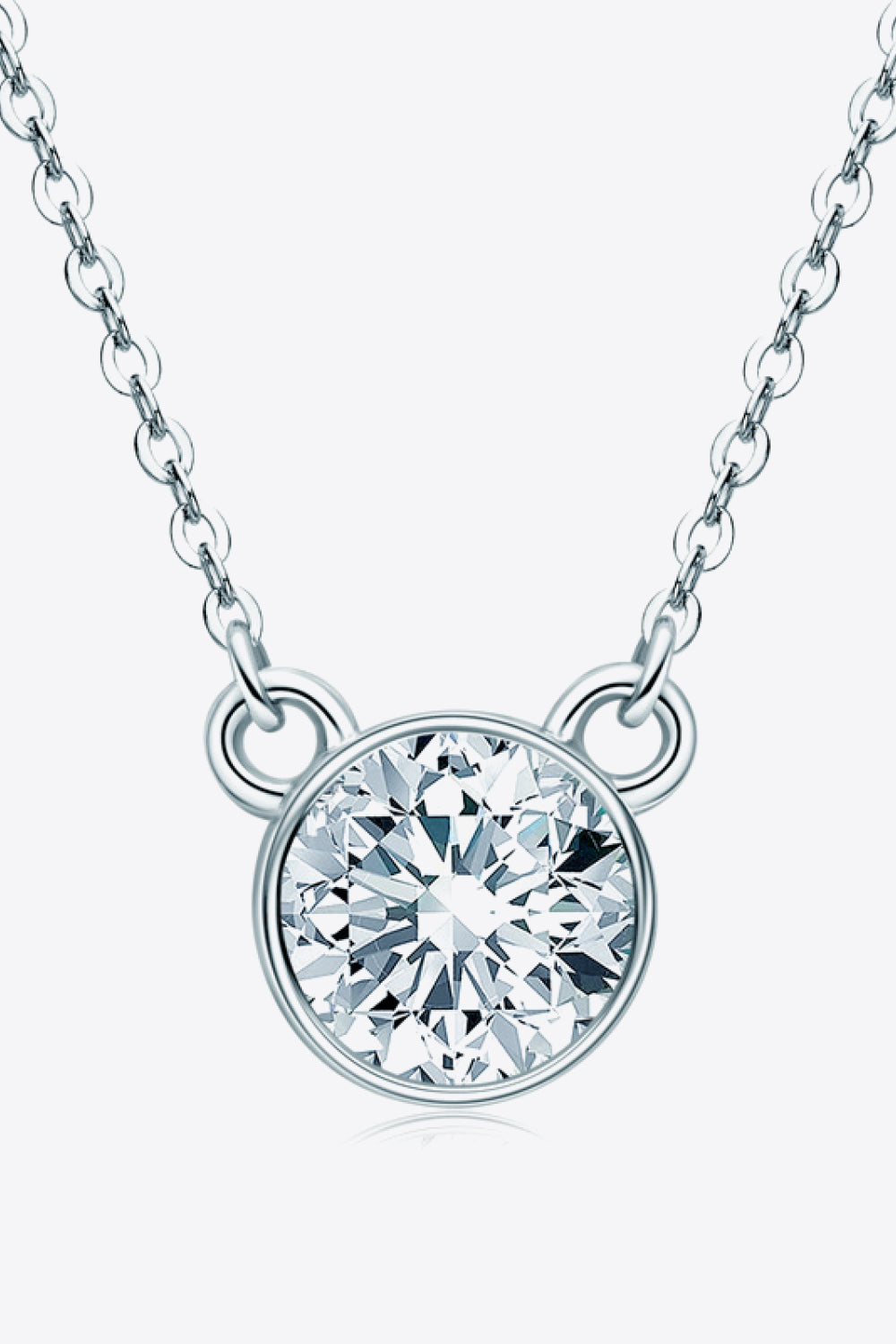 Silver solitaire moissanite bezel necklace with a delicate chain.