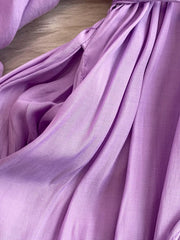 Purple polyester maxi dress with balloon sleeves and a slit detail.