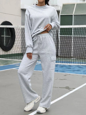 Light gray dropped shoulder sweatshirt and cargo sweatpants set with drawstring waist.
