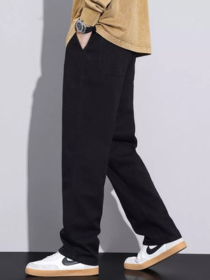 Black relaxed fit cotton jeans with drawstring waist and casual styling.