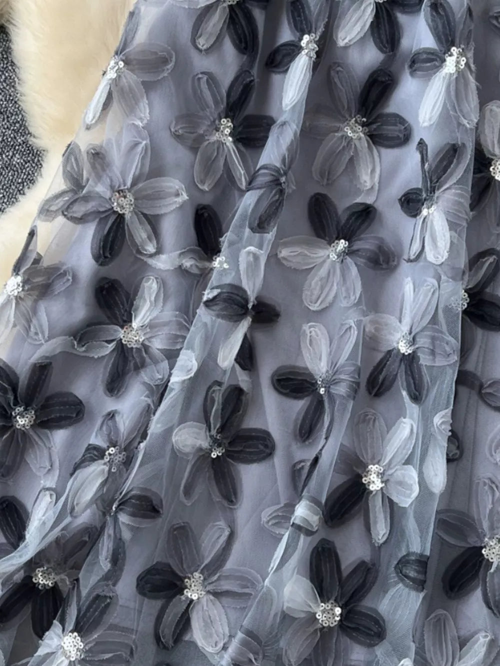 Gray layered skirt with 3D floral embroidery and sequin details.